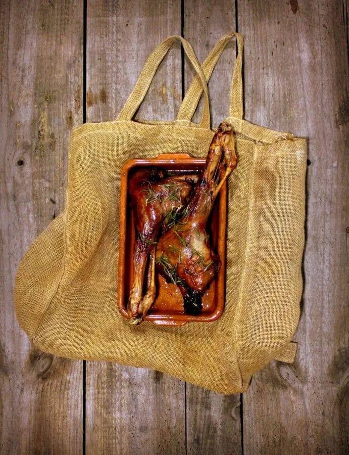 Pierna de cabrito al horno recién asada en su fuente, vista cenital